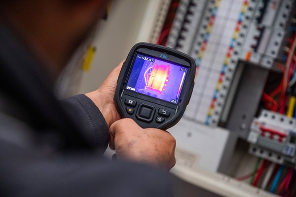Thermal imaging being used on an electrical distribution board - support electrical