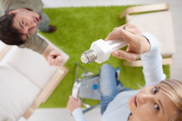Man and woman changing lightbulb